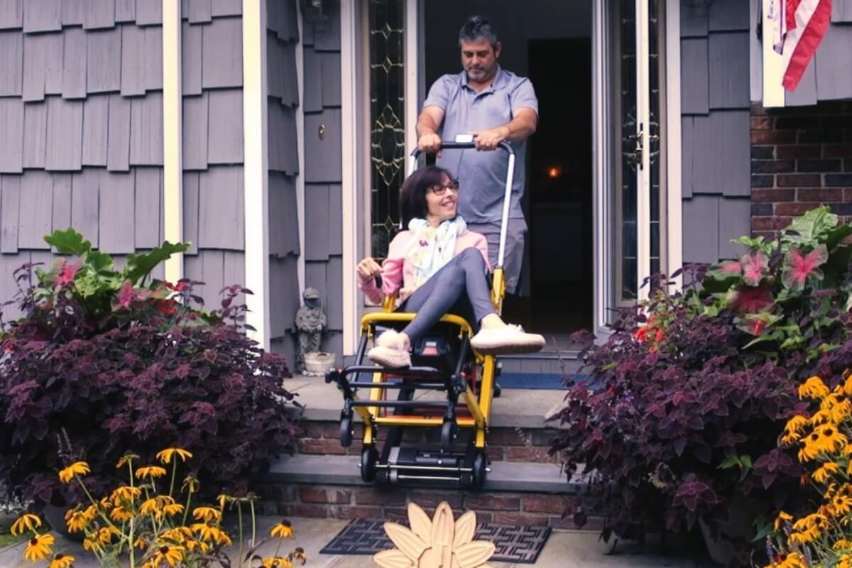 Mobile Stairlift, caregiver assisting child up the stairs